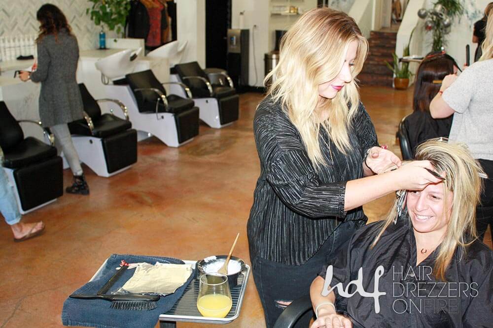 Hairdresser applies color foils to client hair