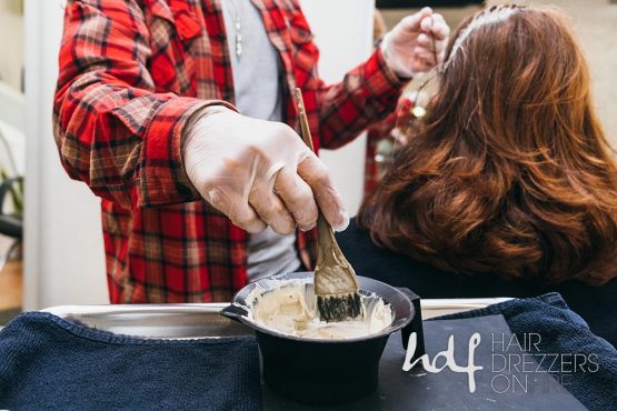 Close up of hair color in a bowl, being applied by stylist