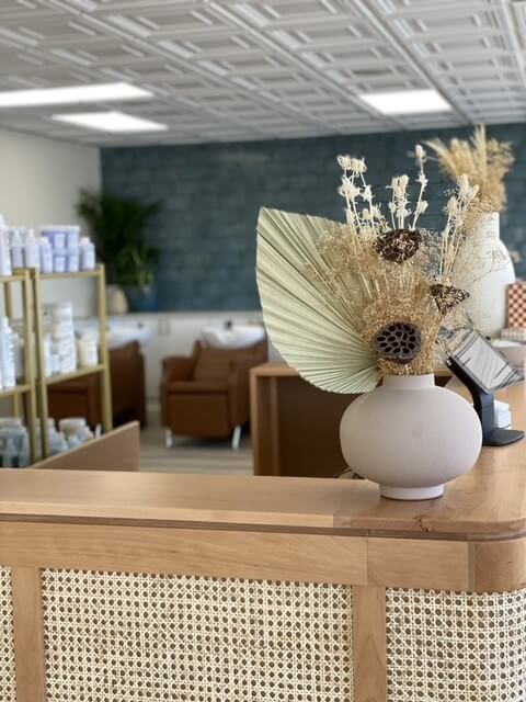 Reception desk in a a salon, dried flowers in pots
