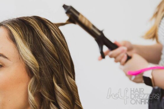 A woman's hair being curled